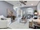 Bright living room with a ceiling fan, open floor plan, sliding glass door to patio, and neutral decor at 30340 Elderwood Dr, Wesley Chapel, FL 33543