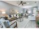 Inviting living room featuring a modern ceiling fan, stylish decor, and an open concept to the dining area at 30340 Elderwood Dr, Wesley Chapel, FL 33543