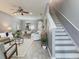 Welcoming living room with an open floor plan, featuring modern décor, wood-look floors, and staircase access at 30340 Elderwood Dr, Wesley Chapel, FL 33543
