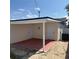 Enclosed back porch with two doors and painted concrete is perfect for outdoor entertaining or storage at 3301 Clydesdale Dr, Holiday, FL 34691