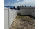 Backyard with a white privacy fence, offering a secure and secluded outdoor space at 3301 Clydesdale Dr, Holiday, FL 34691