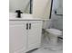 This bathroom is complete with a white vanity, toilet, and a sleek black faucet at 3301 Clydesdale Dr, Holiday, FL 34691