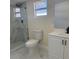 Bright bathroom with marble flooring, a modern vanity, and glass shower at 3301 Clydesdale Dr, Holiday, FL 34691