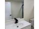 Modern bathroom vanity with white countertop, black faucet, and marble floors at 3301 Clydesdale Dr, Holiday, FL 34691