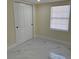 Bedroom with a closet, tile flooring, and window at 3301 Clydesdale Dr, Holiday, FL 34691