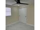 Bedroom features a ceiling fan with a light, white blinds on the window, and a closet with sliding doors at 3301 Clydesdale Dr, Holiday, FL 34691