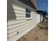 Close up of house exterior featuring modern window, water faucet, and updated siding at 3301 Clydesdale Dr, Holiday, FL 34691