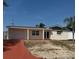 Charming single-story home featuring a red driveway, covered porch and attached garage at 3301 Clydesdale Dr, Holiday, FL 34691