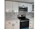Kitchen featuring new stainless steel microwave and range at 3301 Clydesdale Dr, Holiday, FL 34691