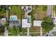 Aerial view of a home with a lush backyard, featuring a pool, jacuzzi, patio, and ample green space at 4003 W Bay Ave, Tampa, FL 33616
