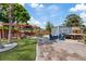 Spacious backyard with pergola, fire pit, hot tub, and green landscaping at 4003 W Bay Ave, Tampa, FL 33616