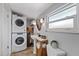Functional bathroom area with stacked washer and dryer and pedestal sink at 4003 W Bay Ave, Tampa, FL 33616