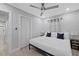 Bright bedroom features light tile flooring, a ceiling fan, and a spacious closet at 4003 W Bay Ave, Tampa, FL 33616