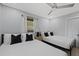 Bright bedroom featuring two beds, ceiling fan and light walls at 4003 W Bay Ave, Tampa, FL 33616