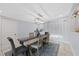 Bright dining room featuring a rustic wooden table, comfortable chairs, stylish decor, and modern lighting at 4003 W Bay Ave, Tampa, FL 33616