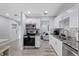 Modern kitchen featuring white cabinets, stainless steel appliances, granite countertops, and stylish backsplash at 4003 W Bay Ave, Tampa, FL 33616