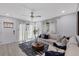 Bright living room with a modern ceiling fan, comfortable seating, and stylish decor at 4003 W Bay Ave, Tampa, FL 33616