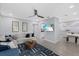Open-concept living area featuring a modern ceiling fan, comfortable seating, and seamless flow to the dining area at 4003 W Bay Ave, Tampa, FL 33616