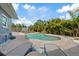 Landscaped backyard features pool with waterfall and paver deck with room for lounging at 4003 W Bay Ave, Tampa, FL 33616