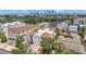 Aerial view of a condo with a red tiled roof, balconies, palm trees, and a city skyline at 406 S Melville Ave # 1, Tampa, FL 33606