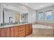 Bathroom features a soaking tub, granite countertop vanity, and a separate glass shower at 406 S Melville Ave # 1, Tampa, FL 33606