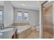 Bathroom boasts a soaking tub, glass shower, and a light-filled interior at 406 S Melville Ave # 1, Tampa, FL 33606