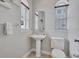 Bright bathroom features pedestal sink, decorative mirror, and natural light at 406 S Melville Ave # 1, Tampa, FL 33606