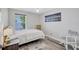 Bedroom with wood-look floors, a window, and modern decor at 406 S Melville Ave # 1, Tampa, FL 33606