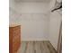 Walk-in closet with wood floors, a wood dresser, and white wire shelving at 406 S Melville Ave # 1, Tampa, FL 33606