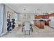 Open-concept dining area with a long table, modern lighting, and stylish decor at 406 S Melville Ave # 1, Tampa, FL 33606
