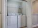 Laundry room with a washer, dryer, and upper shelf at 406 S Melville Ave # 1, Tampa, FL 33606