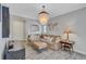 Bright living room featuring a sectional sofa, a chandelier, and decorative accents at 406 S Melville Ave # 1, Tampa, FL 33606