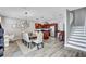 Open living space featuring a dining area, kitchen with an island, and stairs at 406 S Melville Ave # 1, Tampa, FL 33606
