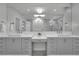 Bright bathroom with double sink vanity, a large mirror, and stylish lighting at 455 Pinellas Bayway S # 2A, Tierra Verde, FL 33715