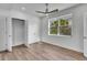 Bedroom with hardwood floors, a closet, and a large window overlooking greenery at 455 Pinellas Bayway S # 2A, Tierra Verde, FL 33715