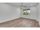 Bedroom with beautiful wood flooring, ceiling fan, and a bright window at 455 Pinellas Bayway S # 2A, Tierra Verde, FL 33715