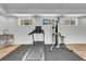 Well-equipped fitness center featuring a treadmill, multi-station weight machine and a wood-look resilient floor at 455 Pinellas Bayway S # 2A, Tierra Verde, FL 33715