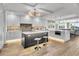 Bright modern kitchen featuring a large island, stainless steel appliances, and wood flooring at 455 Pinellas Bayway S # 2A, Tierra Verde, FL 33715