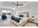 Bright and airy primary bedroom with a view of the water, a sitting area, and a king size bed at 455 Pinellas Bayway S # 2A, Tierra Verde, FL 33715