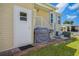 Backyard with a grill, exterior door, and access to a carport; perfect for outdoor living at 4851 W Gandy Blvd # B09L23, Tampa, FL 33611