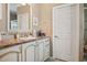 This bathroom has a vanity with white cabinets and tan countertops, plus tile backsplash at 4851 W Gandy Blvd # B09L23, Tampa, FL 33611