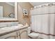 A charming bathroom featuring a white vanity, a framed mirror, and a shower with a striped curtain at 4851 W Gandy Blvd # B09L23, Tampa, FL 33611