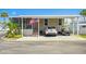 Charming single-story home with covered parking, landscaping, and an American flag at 4851 W Gandy Blvd # B09L23, Tampa, FL 33611