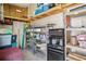 Organized garage space with shelving units, storage containers, and a well-lit upper loft area at 4851 W Gandy Blvd # B09L23, Tampa, FL 33611