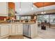 Open-concept kitchen area with a stainless steel dishwasher and access to the adjacent dining area at 4851 W Gandy Blvd # B09L23, Tampa, FL 33611