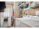 This laundry room features a washer and dryer and shelving with ample storage space for cleaning supplies at 4851 W Gandy Blvd # B09L23, Tampa, FL 33611