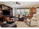 Comfortable living room with plush seating, carpet flooring, natural light, and ceiling fan at 4851 W Gandy Blvd # B09L23, Tampa, FL 33611