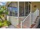 Inviting screened-in porch with a staircase and a cozy seating area and brick-style foundation at 4851 W Gandy Blvd # B09L23, Tampa, FL 33611