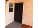 Condo front door and small window with brown trim and concrete floor at 5557 Sea Forest Dr # 216, New Port Richey, FL 34652