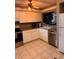 Bright kitchen with white cabinets, stainless steel appliances, and tile flooring at 5557 Sea Forest Dr # 216, New Port Richey, FL 34652